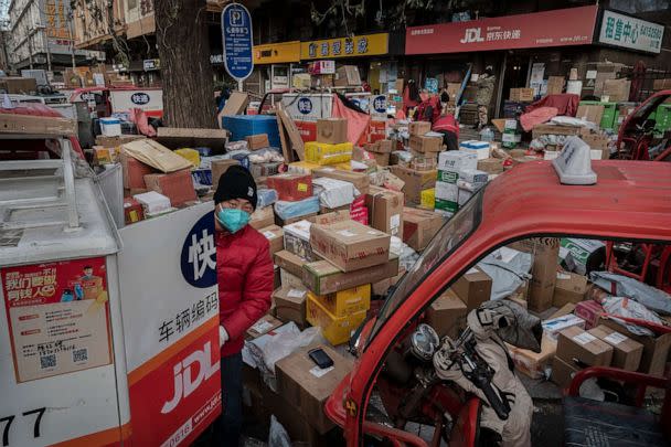 PHOTO: A delivery driver organizes packages in the street that are part of a backlog due to COVID-19 outbreaks outside a depot on Dec. 21, 2022 in Beijing, China. (Kevin Frayer/Getty Images)