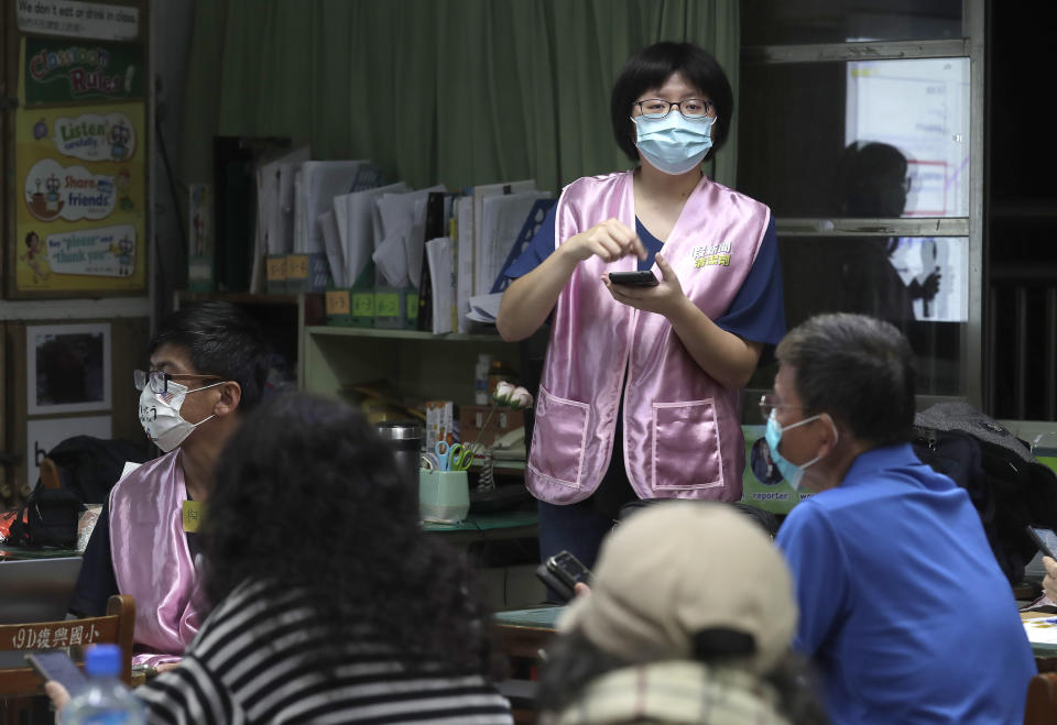 Moon Chen, a volunteer of Fake News Cleaner, guides students through the LINE app to identify fake news during a class in Kaohsiung City, southern Taiwan, Thursday, March 16, 2023. An anti-misinformation group in Taiwan called Fake News Cleaner has hosted more than 500 events, connecting with college students, elementary-school children — and the seniors that, some say, are the most vulnerable to such efforts. (AP Photo/Chiang Ying-ying)