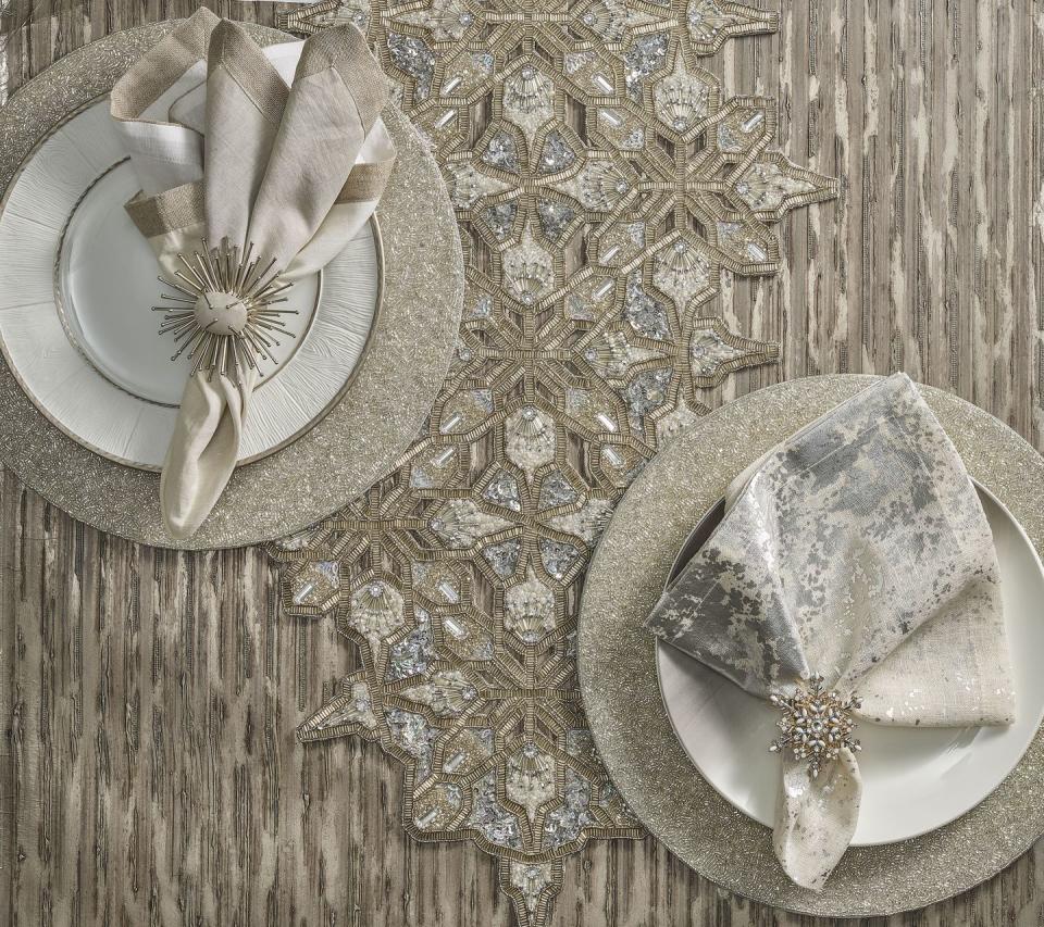 <p>“New Year's Eve can sometimes feel like a whirlwind, but I love designing a table that feels intimate with elements of glamour," Kim Seybert says. "The <a href="https://kimseybert.com/collections/snowflake" rel="nofollow noopener" target="_blank" data-ylk="slk:Snowflake collection;elm:context_link;itc:0;sec:content-canvas" class="link ">Snowflake collection</a> is inspired by nature and brings a sense of softness to the table while the unique, complex shape of the snowflakes adds sparkle and makes the occasion feel special. Using napkins and napkin rings that complement the color scheme keeps the evening feeling intimate and elevated.”</p><p>Whether you're spending your New Year's on a snowy mountaintop or overlooking a white sandy beach, this glitzy, wintry tablescape is perfect for an elegant New Year's Eve dinner for two by the fire or under the stars.</p>