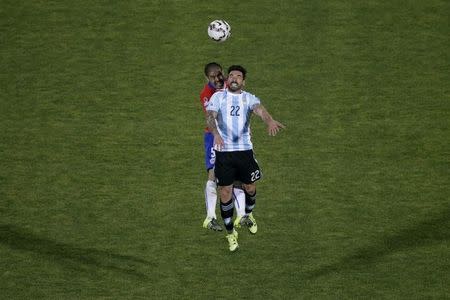 Argentina's Ezequiel Lavezzi and Chile's Francisco Silva (rear) jump for the ball during their Copa America 2015 final soccer match at the National Stadium in Santiago, Chile, July 4, 2015. REUTERS/Ricardo Moraes