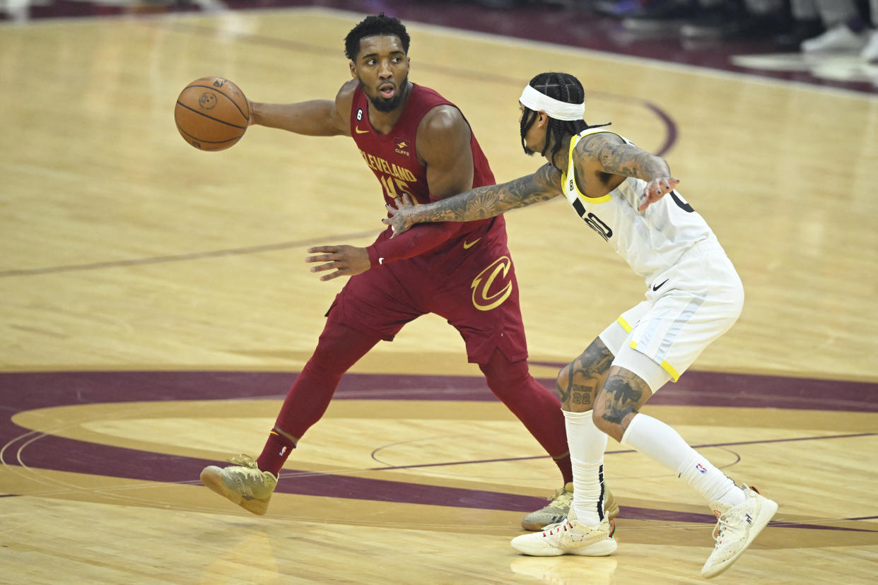Dec 19, 2022; Cleveland, Ohio, USA; Utah Jazz guard Jordan Clarkson (00) defends Cleveland Cavaliers guard Donovan Mitchell (45) in the first quarter at Rocket Mortgage FieldHouse. Mandatory Credit: David Richard-USA TODAY Sports