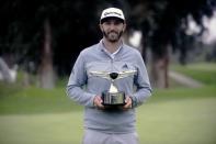 February 19, 2017; Pacific Palisades, CA, USA; Dustin Johnson celebrates his victory following the final round of the Genesis Open golf tournament at Riviera Country Club. Mandatory Credit: Gary A. Vasquez-USA TODAY Sports