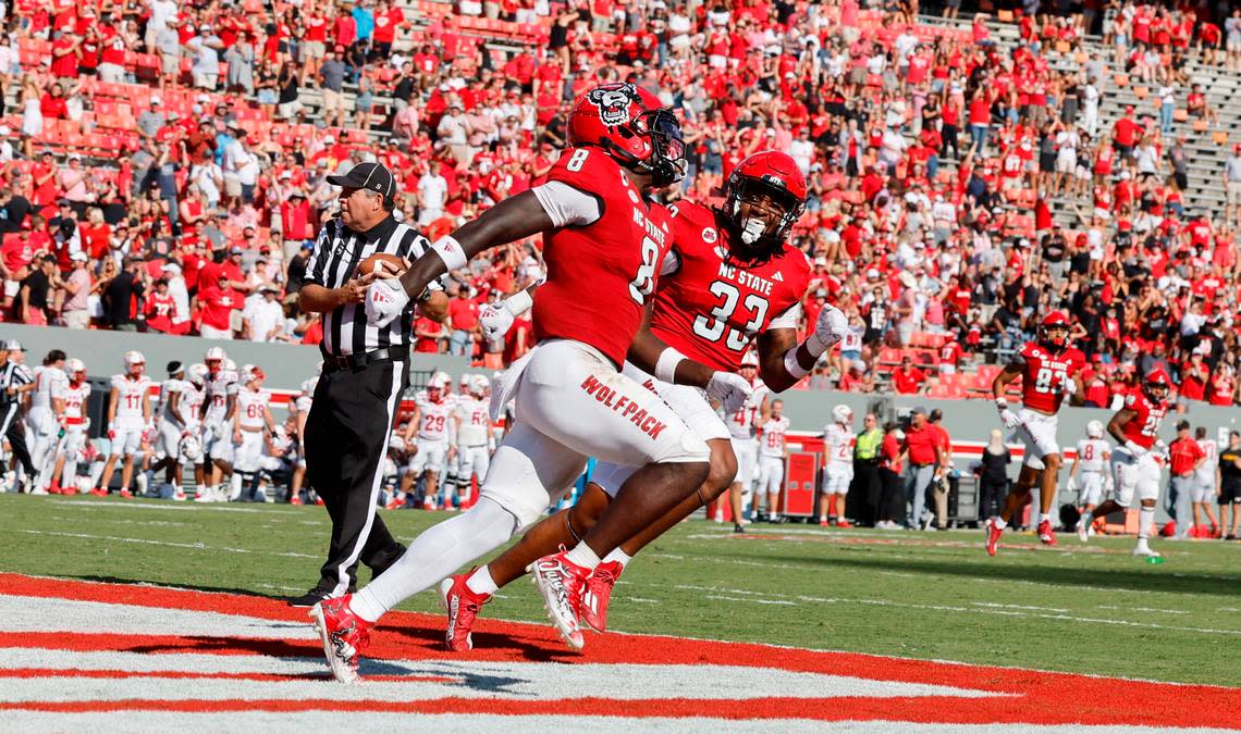 N.C. State’s Jordan Poole (33) celebrates with Julian Gray (8) after Gray scored a touchdown on a 82-yard kickoff return during the second half of the Wolfpack’s 45-7 victory over VMI at Carter-Finley Stadium in Raleigh, N.C., Saturday, Sept. 16, 2023.