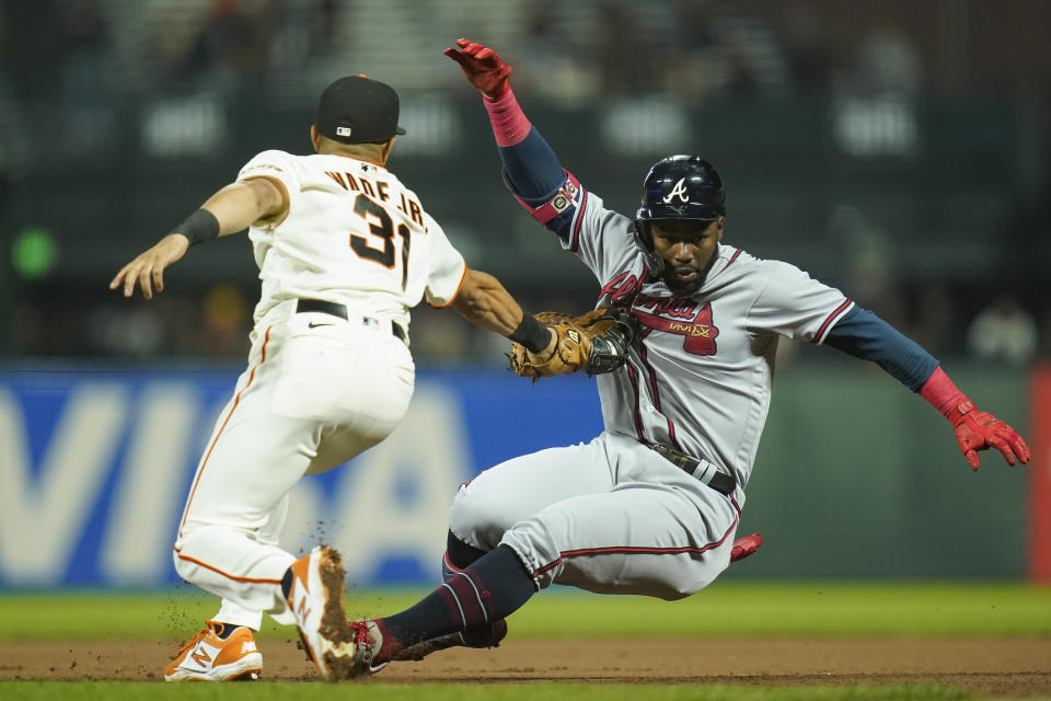 San Francisco Giants first baseman LaMonte Wade Jr. (31) tags out Atlanta Braves' Michael Harris II, who singled, at first on the throw from center fielder Lewis Brinson during the seventh inning of a baseball game in San Francisco, Monday, Sept. 12, 2022. (AP Photo/Godofredo A. Vásquez)