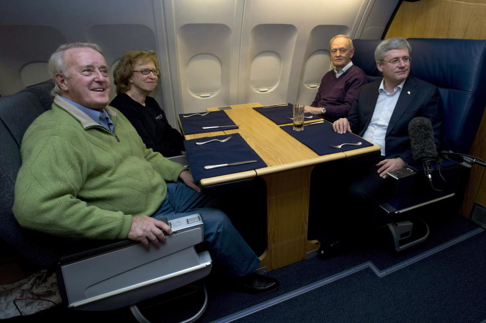 Canadian Prime Minister Stephen Harper, right, speaks with former Prime Ministers Brian Mulroney, from left to right, Kim Campbell and Jean Chretien on board a government plane traveling to South Africa, Sunday Dec. 8, 2013. Mulroney has died at the age of 84, his daughter Caroline Mulroney posted on social media, Thursday, Feb. 29, 2024. (Adrian Wyld/The Canadian Press via AP)