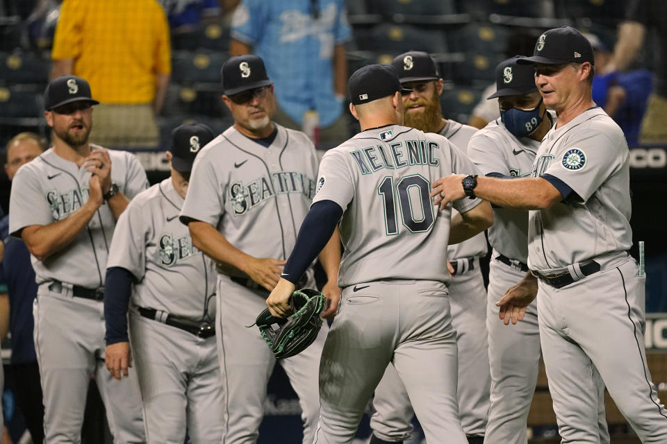 Seattle Mariners' Jarred Kelenic (10) celebrates with teammates after their baseball game against the Kansas City Royals Friday, Sept. 17, 2021, in Kansas City, Mo. Seattle won 6-2. (AP Photo/Charlie Riedel)