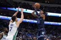 Dallas Mavericks center Dwight Powell (7) defends against a shot by Memphis Grizzlies' Ja Morant (12) in the first half of an NBA basketball game in Dallas, Sunday, Jan. 23, 2022. (AP Photo/Tony Gutierrez)