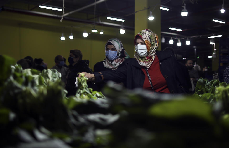 People shop in a market in Istanbul, Saturday, May 8, 2021, after they were allowed to open during the strict lockdown. The markets, or "bazaars," integral to Turkish food culture with producers bringing their fruits and vegetables to nearly every neighborhood on set days of the week, were allowed to open Saturday across Turkey as the country's strictest lockdown to fight COVID-19 continues amid an economic downturn with double digit inflation. (AP Photo/Emrah Gurel)