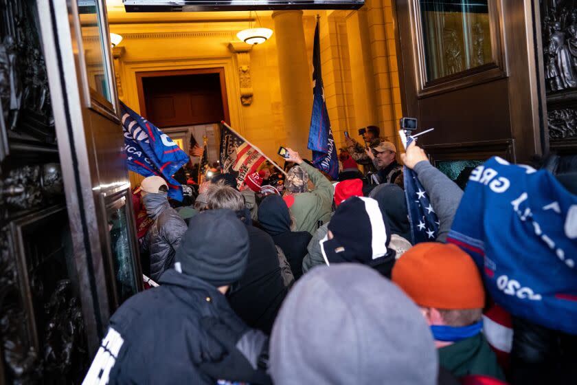 WASHINGTON, DC - JANUARY 06: Insurrectionists stream into the U.S. Capitol building after breaching through the East Door on the second day of pro-Trump events fueled by President Donald Trump's continued claims of election fraud in an to overturn the results before Congress finalizes them in a joint session of the 117th Congress on Wednesday, Jan. 6, 2021 in Washington, DC. (Kent Nishimura / Los Angeles Times)