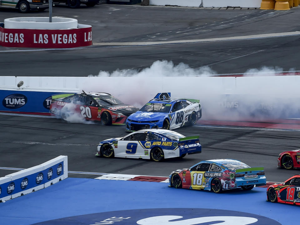 Erik Jones (20) and Alex Bowman (88) spin during the NASCAR Cup Series auto race at Charlotte Motor Speedway Sunday, Sept. 29, 2019 in Concord, N.C. (AP Photo/Mike McCarn)