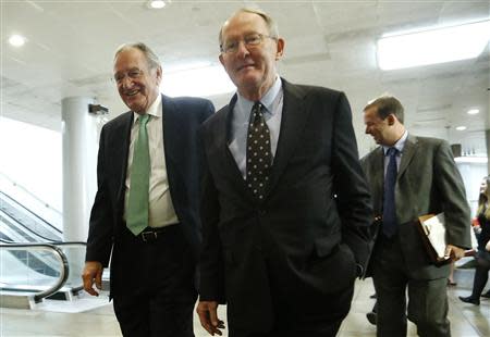 U.S. Senator Tom Harkin (D-IA) (L) and Senator Lamar Alexander (R-TN) (C) walk to a closed-door briefing on talks with Iran by Secretary of State John Kerry and Treasury Secretary Jack Lew at the U.S. Capitol in Washington December 11, 2013. REUTERS/Jonathan Ernst