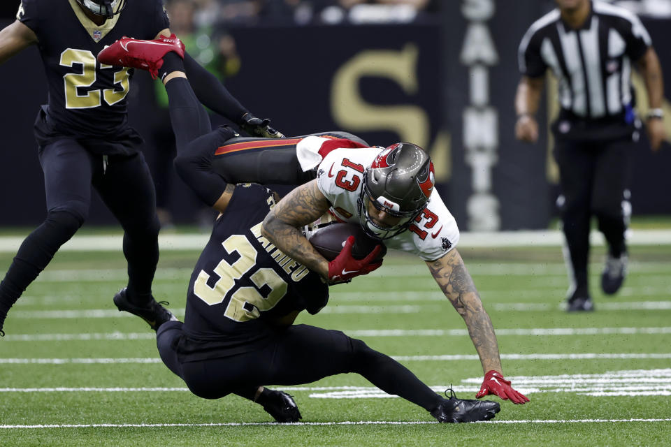 Tampa Bay Buccaneers wide receiver Mike Evans is tackled by New Orleans Saints safety Tyrann Mathieu during the first half of an NFL football game in New Orleans, Sunday, Sept. 18, 2022. (AP Photo/Butch Dill)