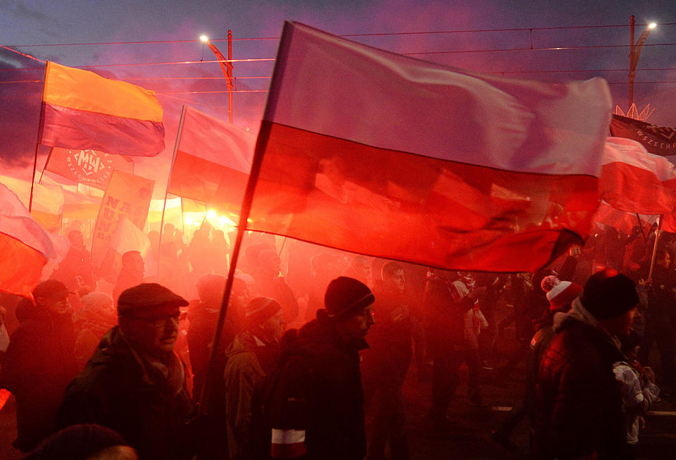 <p>Demonstrators burn flares and wave Polish flags during the annual march to commemorate Poland’s National Independence Day in Warsaw, Saturday, Nov. 11, 2017. Thousands of nationalists marched in Warsaw on Poland’s Independence Day holiday, taking part in an event that was organized by far-right groups. (Photo: Czarek Sokolowski/AP) </p>