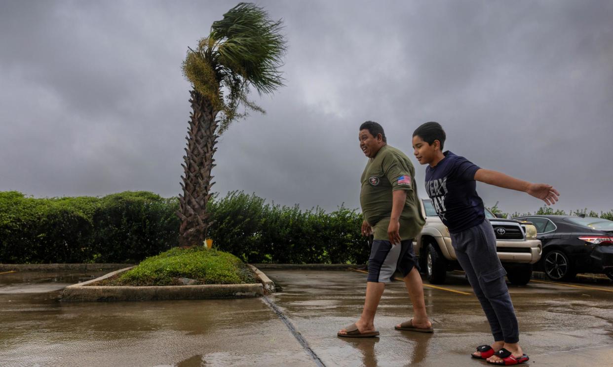 <span>Lazaro Cardoso, 11, leans into powerful winds from Hurricane Francine alongside his father, Hugo Gonzales, in Houma, Louisiana.</span><span>Photograph: Chris Granger/AP</span>