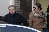 President of the Federation Internationale de l'Automobile, F.I.A., Jean Todt, left, and his companion, Michelle Yeoh, leave the hospital where former seven-time Formula One champion Michael Schumacher is being treated after sustaining a head injury during a ski accident, in Grenoble, France, Wednesday, Jan. 1, 2014. Schumacher's condition was stable but still critical as he remained unconscious, his manager said Wednesday. (AP Photo/Thibault Camus)