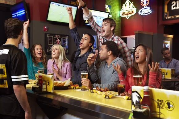 Patrons cheering a sporting event at Buffalo Wild Wings