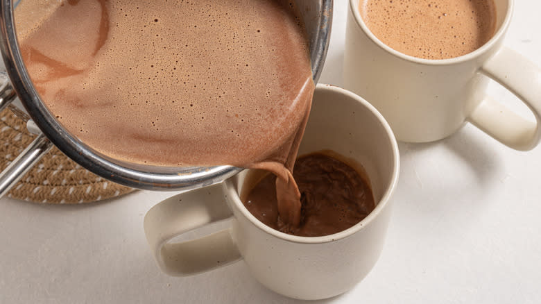 Pouring hot chocolate into a mug
