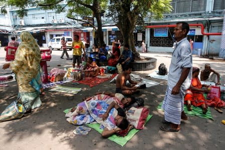 Patients and their relatives wait for treatment at a government hospital during a strike by doctors demanding security after the recent assaults on doctors by the patients' relatives, in Kolkata