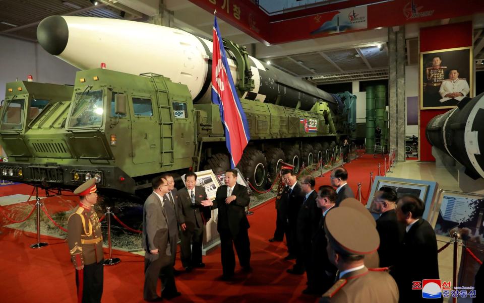 Mr Kim speaking last week in front of one of the North's intercontinental hypersonic missiles - REUTERS