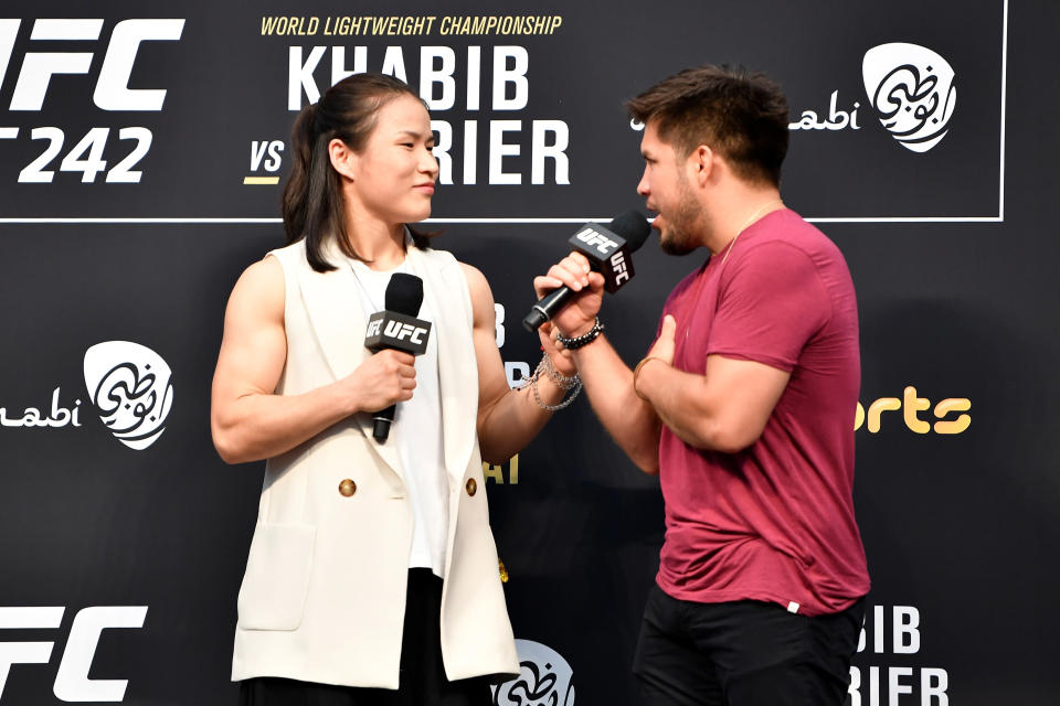 ABU DHABI, UNITED ARAB EMIRATES - SEPTEMBER 06:  (L-R) Women's strawweight champion Zhang Weili and flyweight and bantamweight champion Henry Cejudo interact during a Q&A prior to the UFC 242 weigh-in at The Arena on September 6, 2019 in Abu Dhabi, United Arab Emirates. (Photo by Jeff Bottari/Zuffa LLC/Zuffa LLC via Getty Images)