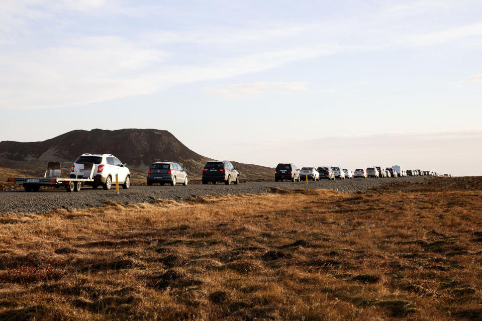 A line of cars queued on a road heading to Grindavik, Iceland on Nov. 13, 2023. Residents of Grindavik, a town in southwestern Iceland, have been briefly allowed to return to their homes on Monday after being told to evacuate on Saturday after increasing concern about a potential volcanic eruption caused civil defense authorities to declare a state of emergency in the region. (Brynjar Gunnarsson)