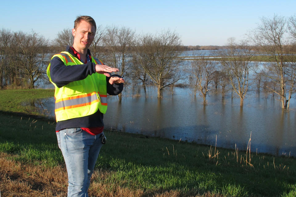 Cody Isbell, a geotechnical engineer with the U.S. Army Corps of Engineers, speaks with a reporter about flooding protection along the Ensley levee near the Mississippi River in Memphis, Tenn., on Thursday, March 21, 2019. (AP Photo/Adrian Sainz)