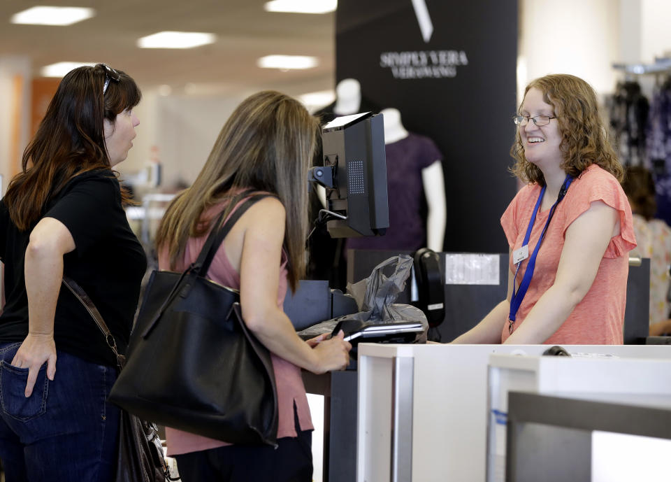 In this Tuesday, Aug. 28, 2018, file photo cashier Liz Moore, right, checks out customers Christie Meeks, center, and Lisa Starnes, left, at a Kohl's store in Concord, N.C. Many kinds of chains have posted strong sales, both online and at stores. A booming economy, which has shoppers spending more freely, and companies' own efforts in trying to Amazon-proof their business is driving people’s mood to spend. (AP Photo/Chuck Burton)