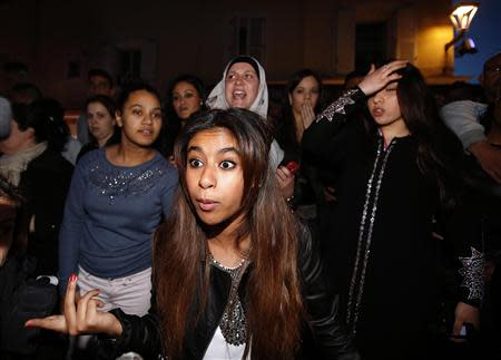 Women react in front of the campaign headquarters of David Rachline, France's far-right National Front political party member and head of the list for municipal elections, after Rachline won in the second round in the French mayoral elections in Frejus March 30, 2014. REUTERS/Eric Gaillard