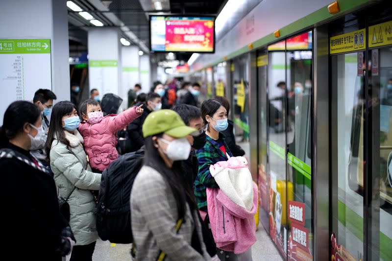 People wearing face masks wait for a subway train on the first day the city's subway services resumed following the novel coronavirus disease (COVID-19) outbreak in Wuhan