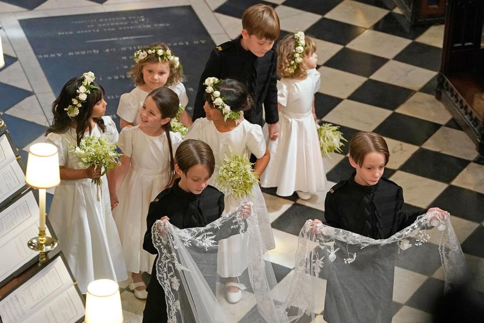 Bridesmaids and Page Boys, including John and Brian Mulroney, walk behind US actress Meghan Markle during her wedding to Britain's Prince Harry, Duke of Sussex