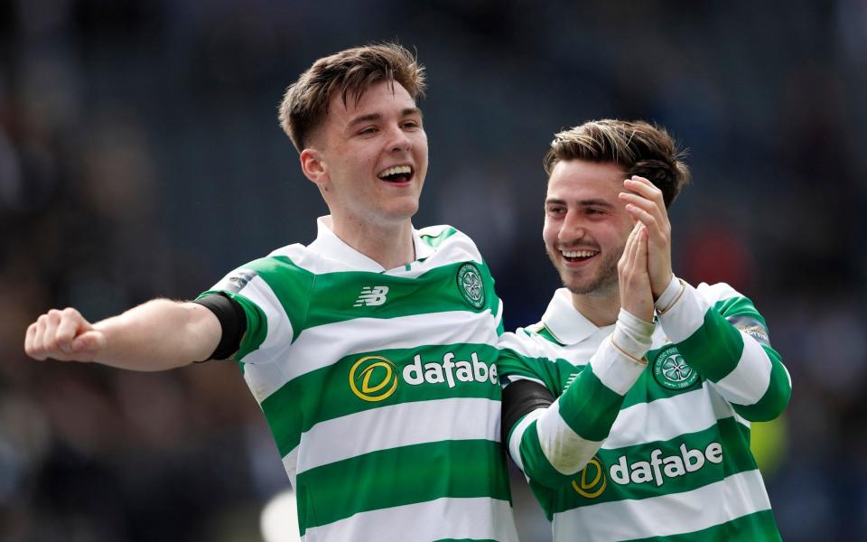 Celtic's Kieran Tierney and Patrick Roberts celebrate after the match - Credit: REUTERS