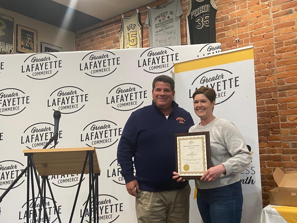 Mayor Tony Roswarski, left, honors Sweet Revolution in downtown Lafayette as the Small Business of the Month.  Representing the bakery is Sarah McGregor-Ray, chef and co-owner of Sweet Revolution.