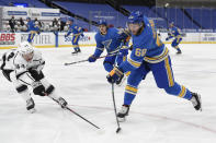 Los Angeles Kings' Mikey Anderson (44) attempts to block a shot from St. Louis Blues' Mike Hoffman (68) during the second period of an NHL hockey game Saturday, Jan. 23, 2021, in St. Louis. (AP Photo/Joe Puetz)