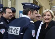 French far-right leader and presidential candidate Marine Le Pen smiles as she visits a border post Monday Feb. 13, 2017 in Menton, southern France, at the border with Italy. Le Pen wants France to better control its borders to fight illegal arrivals, quitting the border-free Schengen zone as well as the European Union. (AP Photo/Christian Alminana)