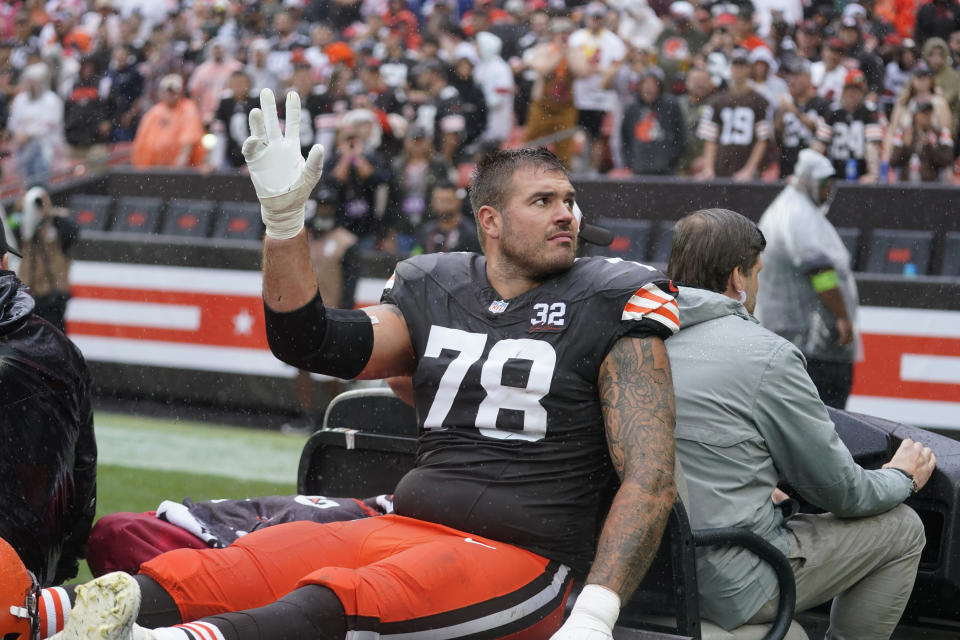Jack Conklin left the field on a cart after injuring his knee against the Bengals. (AP Photo/Sue Ogrocki)