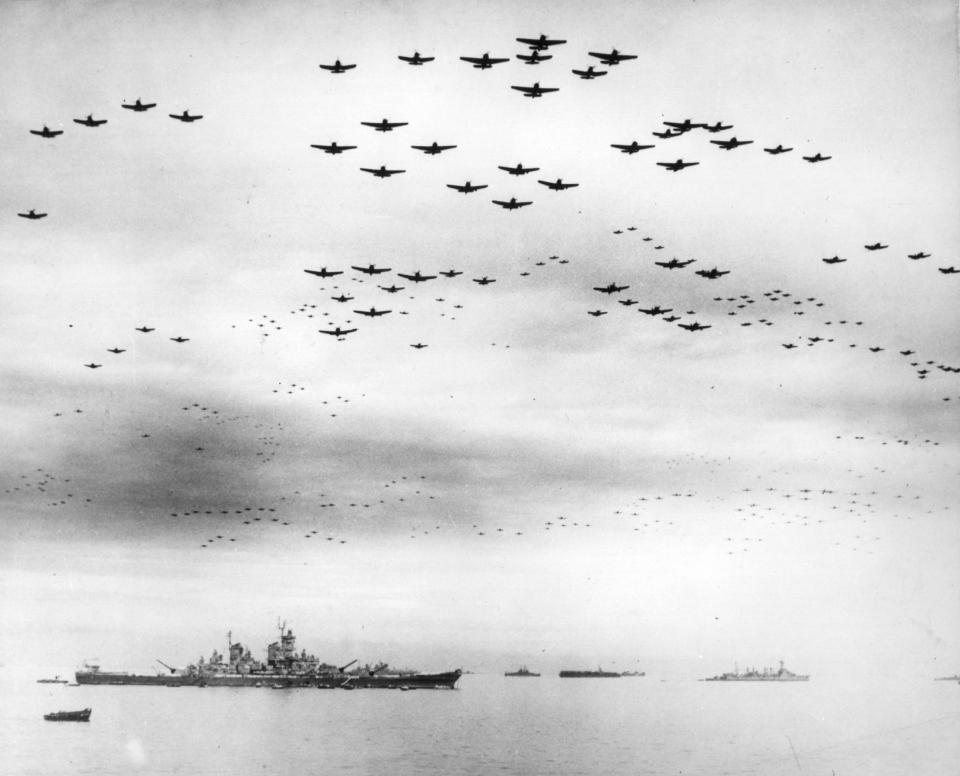 FILE - In this image provided by the U.S. Navy, fighter planes fly in formation over the USS Missouri, while the surrender ceremonies to end World War II take place aboard the U.S. Navy battleship, on Sept. 2, 1945. Several dozen aging U.S. veterans, including some who were in Tokyo Bay that day, will gather in Pearl Harbor in September to mark the 75th anniversary of Japan's surrender, even if it means the vulnerable group may be risking their lives again amid the coronavirus pandemic. (U.S. Navy via AP, File)