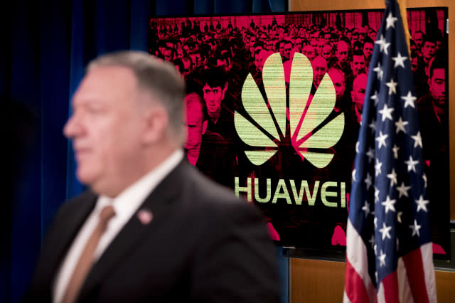 A monitor displays the logo for Huawei behind Secretary of State Mike Pompeo as he speaks during a news conference at the State Department in Washington,DC on July 15, 2020. - US Secretary of State Mike Pompeo said Wednesday he will visit Britain and Denmark next week, days after London pleased Washington with a ban on Chinese telecom giant Huawei. "I leave on Monday for a quick trip to the United Kingdom and Denmark, and I'm sure that the Chinese Communist Party and its threat to free peoples around the world will be high on top of that agenda," Pompeo told a news conference. (Photo by Andrew Harnik / POOL / AFP) (Photo by ANDREW HARNIK/POOL/AFP via Getty Images)
