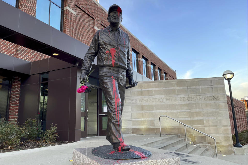 The statue of the late University of Michigan football coach Bo Schembechler was vandalized on Wednesday morning, Nov. 24, 2021 in Ann Arbor, Mich. The vandal referenced Schembechler's alleged knowledge of the late team doctor Robert Anderson's sex abuse of hundreds of players for multiple decades. (Sam Dodge/Jackson Citizen Patriot via AP)