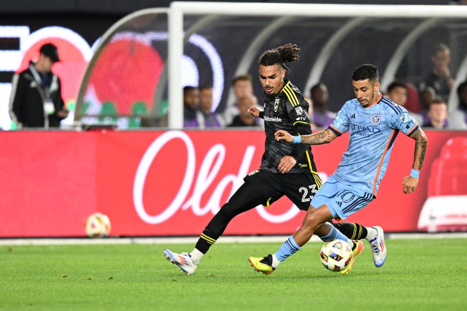 Jun 14, 2024; New York, New York, USA; New York City FC midfielder Santiago Rodriguez (10) plays the ball defend by Columbus Crew defender Mohamed Farsi (23) in the first half at Yankee Stadium. Mandatory Credit: Mark Smith-USA TODAY Sports