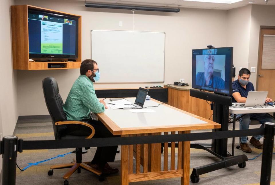 Central District Health District Director Russell Duke is recorded live from the CDH meeting room while the board members are virtually displayed on a screen on Tuesday, Sept. 14, 2021.