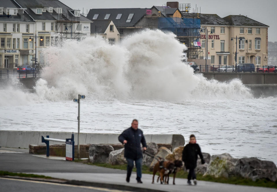 Huge waves hit the sea wall in Porthcawl, Wales, as gales of up to 80mph from Storm Brendan caused disruption around the UK.