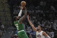 Boston Celtics guard Jaylen Brown (7) shoots over Cleveland Cavaliers guard Max Strus during the first half of Game 3 of an NBA basketball second-round playoff series Saturday, May 11, 2024, in Cleveland. (AP Photo/Sue Ogrocki)