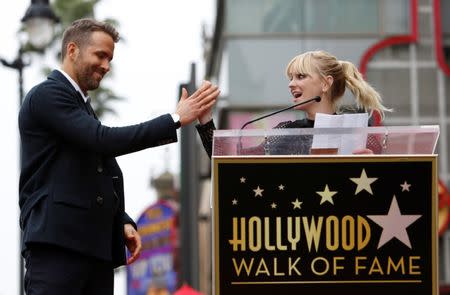 Actor Anna Faris gives a high-five to actor Ryan Reynolds before the unveiling of his star on the Hollywood Walk of Fame in Hollywood, California U.S., December 15, 2016. REUTERS/Mario Anzuoni