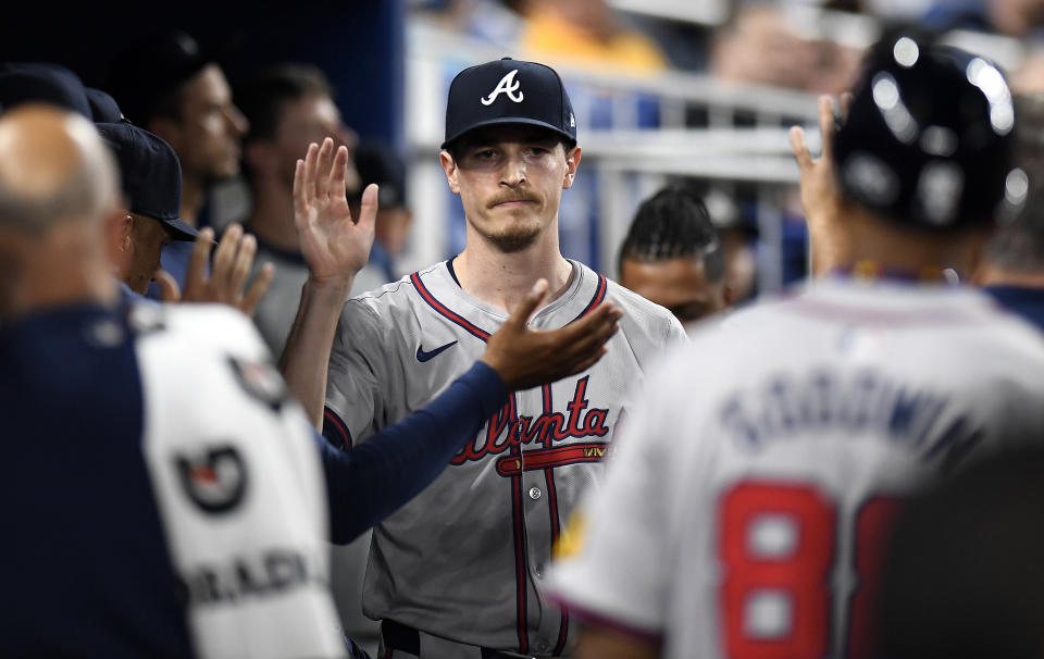 Atlanta Braves pitcher Max Fried is greeted after working in the seventh inning against the Miami Marlins in a baseball game Friday, April 12, 2024, in Miami. (AP Photo/Michael Laughlin)