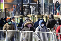 People line up outside Elmhurst Hospital Center to be tested for the coronavirus, Tuesday, March 24, 2020, in the Queens borough of New York. New York Gov. Andrew Cuomo says the number of positive coronavirus cases in the state surged to more than 20,000, with more than half the cases in New York City. (AP Photo/Mary Altaffer)