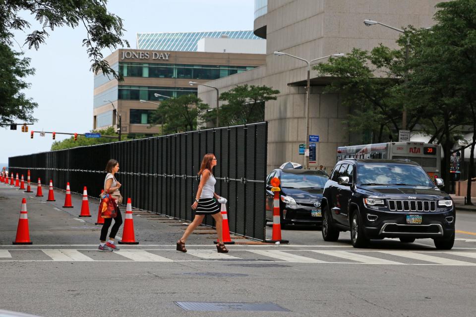 Pedestrians cross East Ninth Street in downtown Cleveland, Ohio.