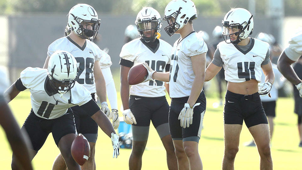 UCF football players, pictured here on the practice field in Florida.