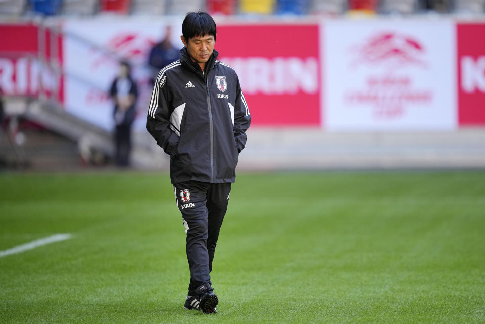 FILE - Head coach Hajime Moriyasu walks on the pitch during a training session of Japan's national soccer team in Duesseldorf, Germany, prior a friendly match against the USA, Thursday, Sept. 22, 2022. The World Cup in Qatar will have an unusually truncated build-up to the tournament. World Cups typically take place in June and July at the end of a traditional European soccer season and teams have about three weeks to prepare. (AP Photo/Martin Meissner, File)