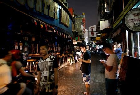 Neon-light advertisements are switched off following the death of Thailand's King Bhumibol Adulyadej at the Soi Cowboy tourist area in Bangkok, Thailand October 16, 2016. Picture taken October 16, 2016. REUTERS/Issei Kato/Files