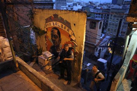 A police officer from the Pacifying Police Unit (UPP) patrols the streets of the Cantagalo slum in Rio de Janeiro March 13, 2014. REUTERS/Pilar Olivares